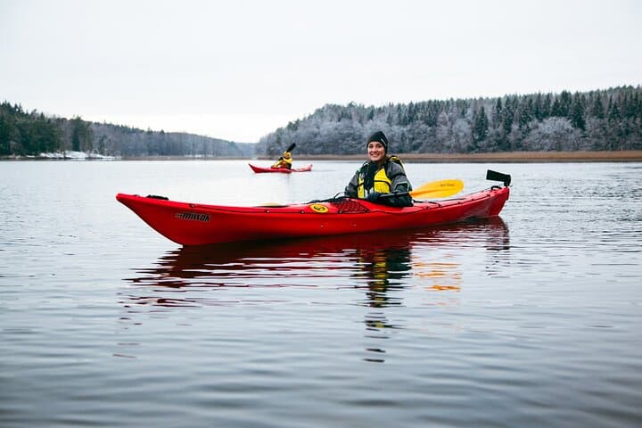 A peaceful winter scene — paddling between snowy islands surrounded by crisp Scandinavian air